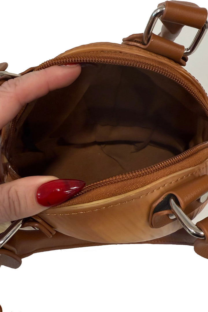 Brown  snail handbag with a hand opening it on a white background