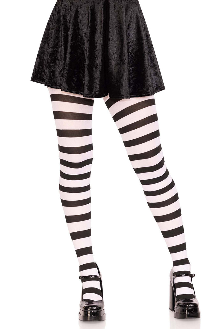 Black and white striped tights worn with a black skirt on a white background