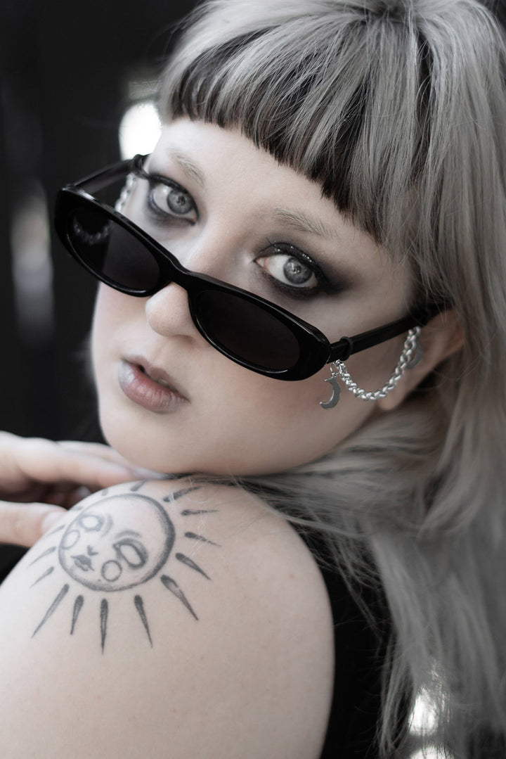 womens dark gothic dramatic thin oval black sunglasses with crescent moon charms 