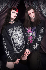 goth couple wearing gothic sweatshirts