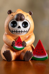 Skeleton capybara resin toy statue holding a watermelon on a white background
