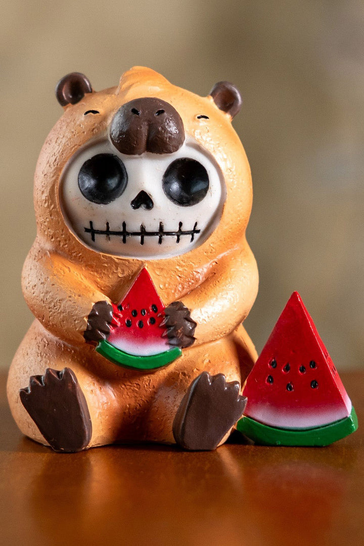 Skeleton capybara resin toy statue holding a watermelon on a white background