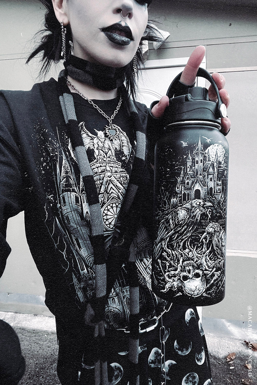 gothic girl holding a stainless steel large horror raven skeleton water bottle 