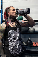 tattooed guy using skeleton stainless steel water bottle at gym