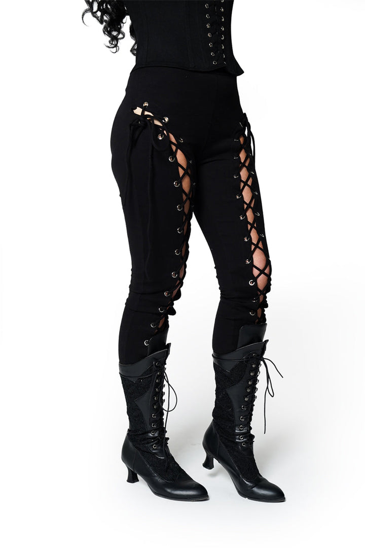Black lace-up outfit with high boots on a white background