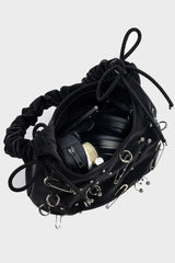punk shoulder bag with piercings and safety pins