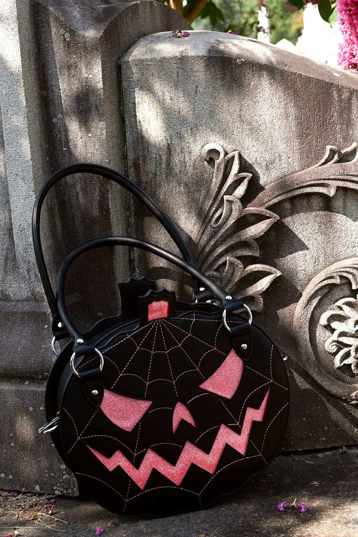 black and pink pumpkin purse