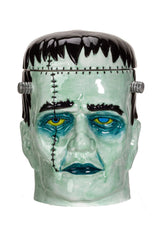 Frankenstein monster head cookie jar with green face and black hair on a white background