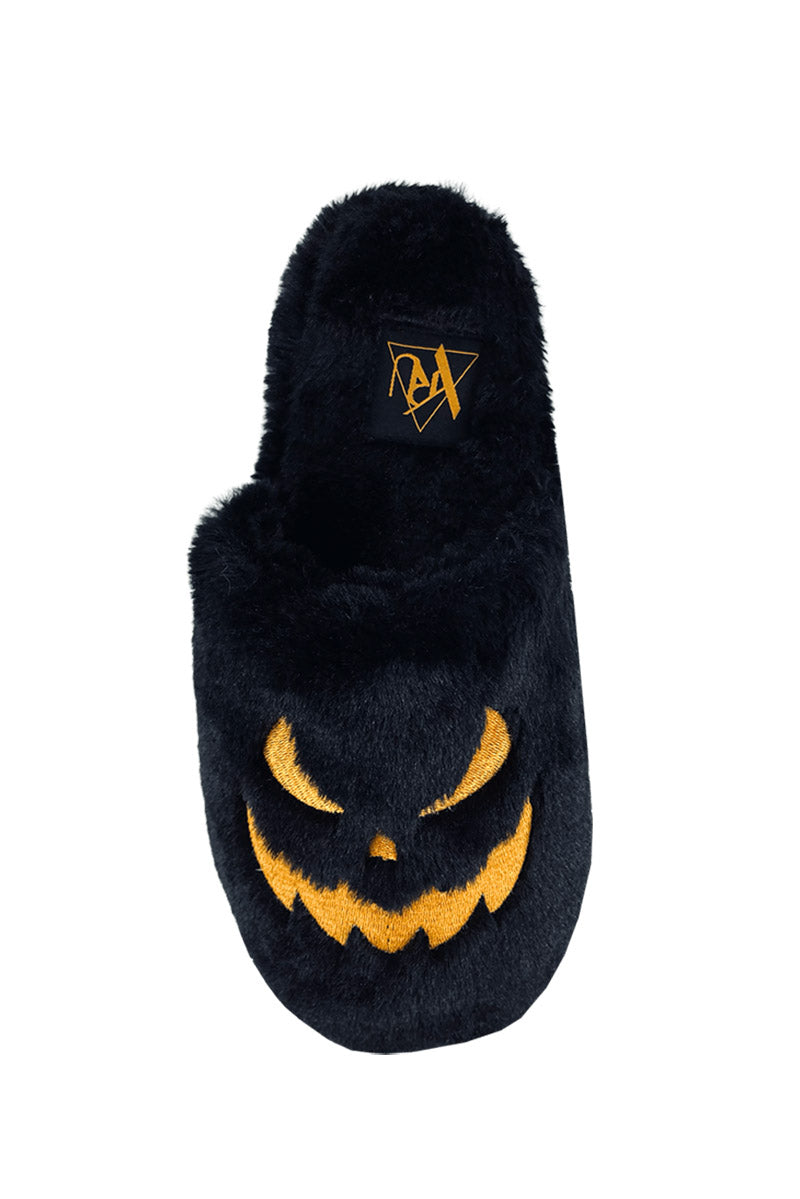 black furry slippers with embroidered pumpkin faces