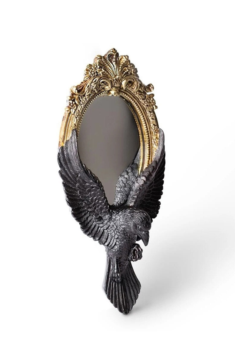ornate gold cameo frame and raven mirror