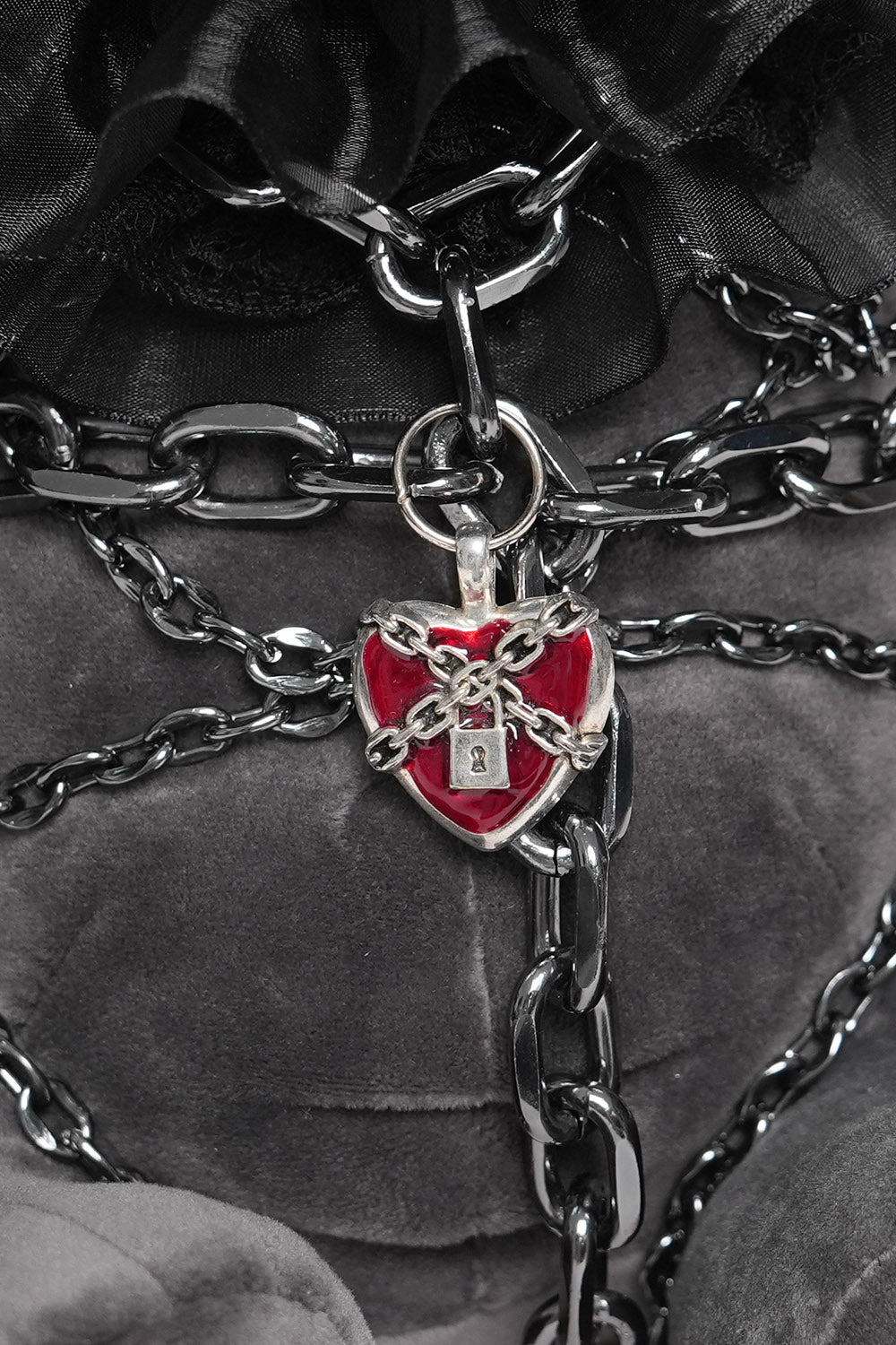 chained punk rabbit plush toy wearing a lolita ruffle headband and heart locket 