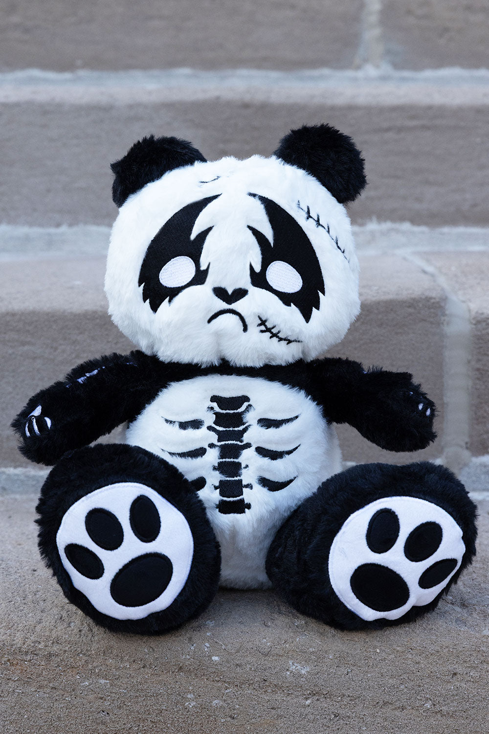 Stuffed bear with skeleton embroidery