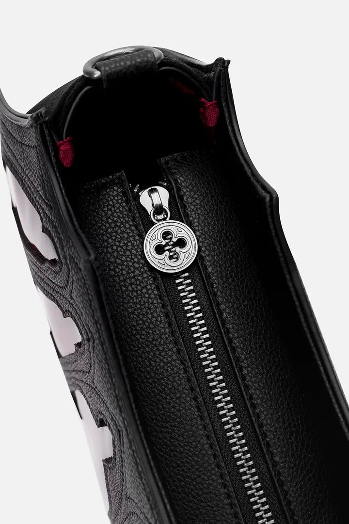 Close-up of a black leather  wallet  with a zipper and decorative emblem on a white background