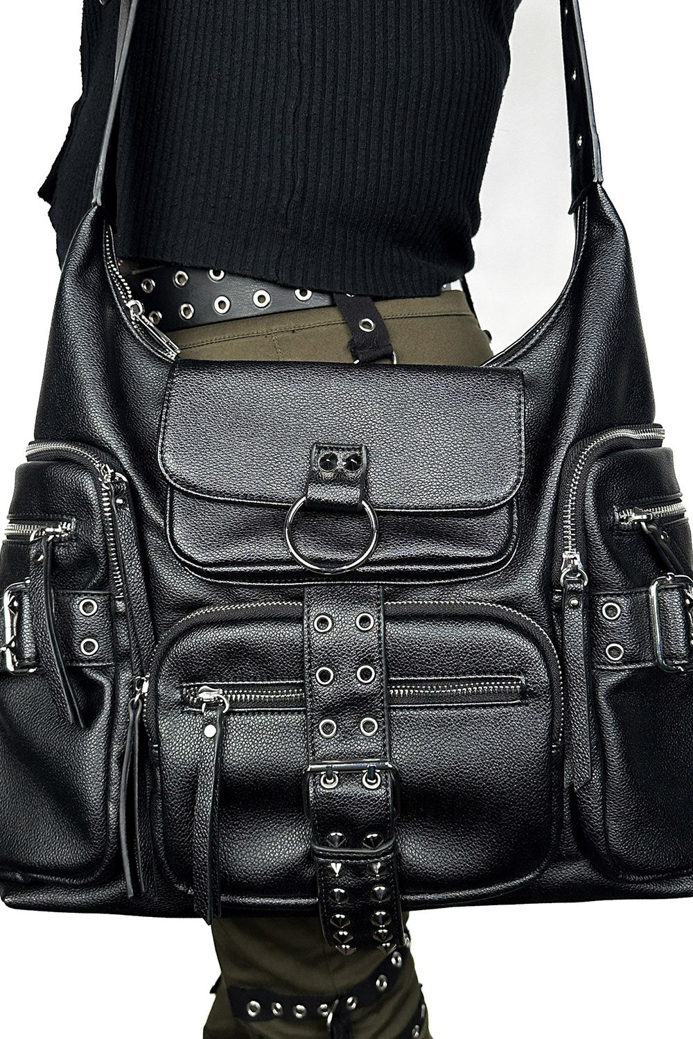 Black leather bag with studs and buckles on a plain background