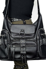 Black leather bag with studs and buckles on a plain background