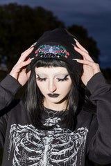 Alternative goth beanie hat with mystical moth embroidery blooming roses and spooky spiderweb details for emo punk fashion