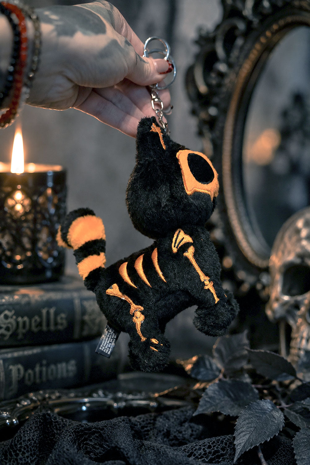 creepy cute plush black and orange cat keychain with embroidered bones