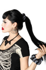 gothic hair accessory duo features one sleek black-and-grey striped scrunchie and one covered in a flock of flying bats
