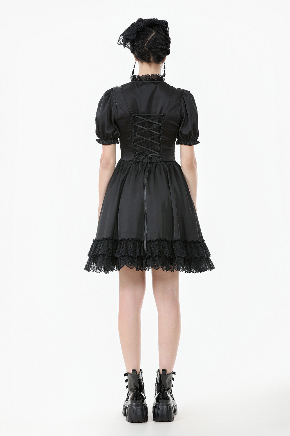Black gothic-style dress with lace details on a white background