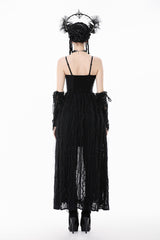 Black dress with sheer panels and intricate detailing on a white background