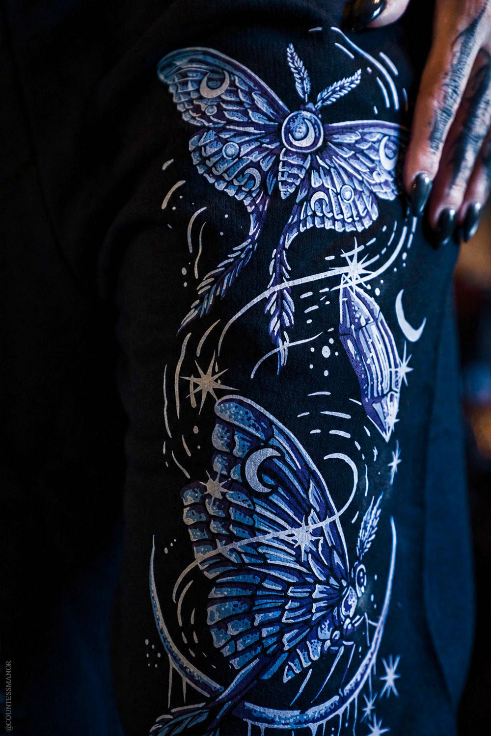 Luna moth blue and purple print on black pants