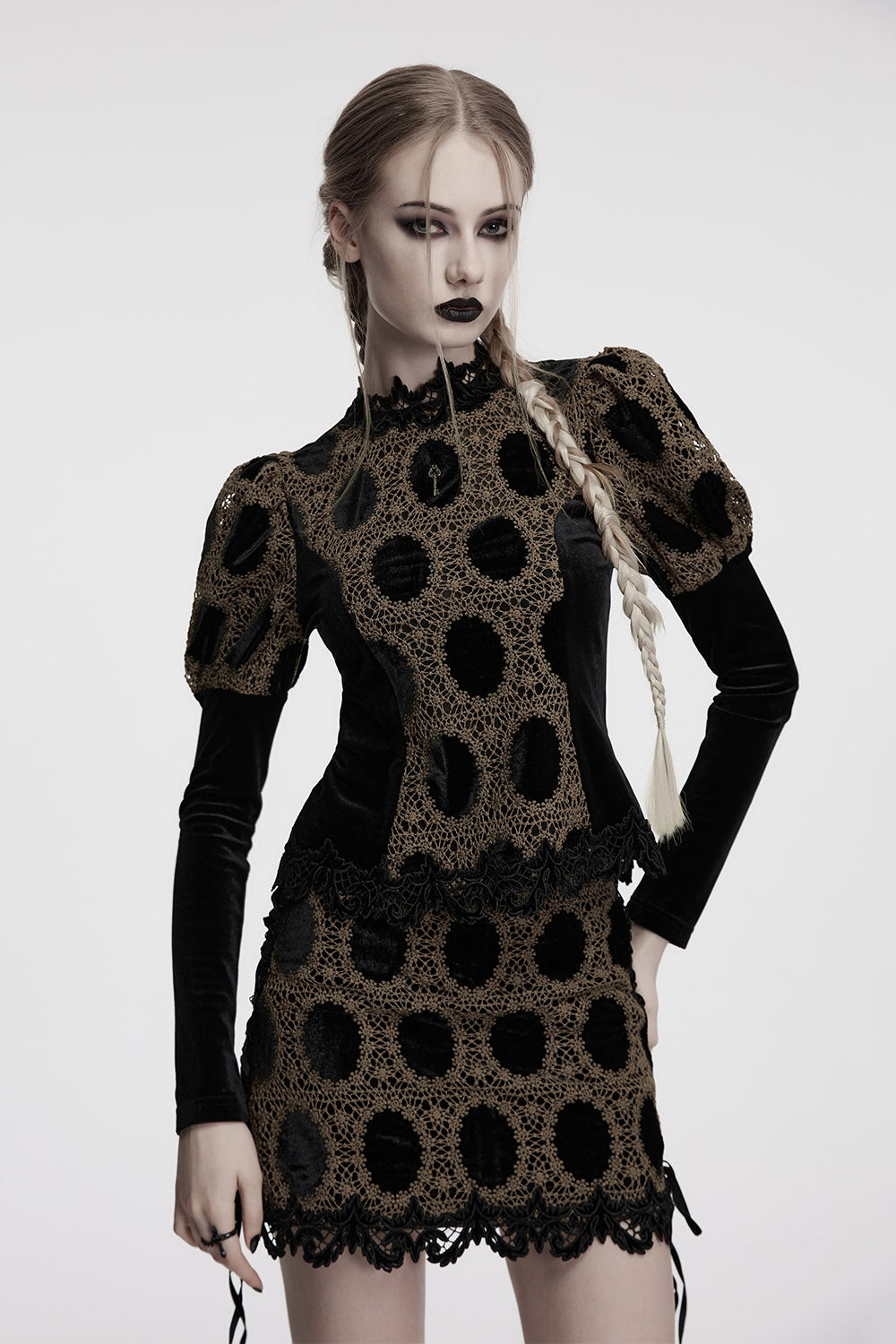 Woman wearing a black and brown patterned blouse on a white background