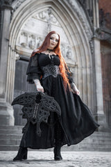Model holding gothic moth wing backpack