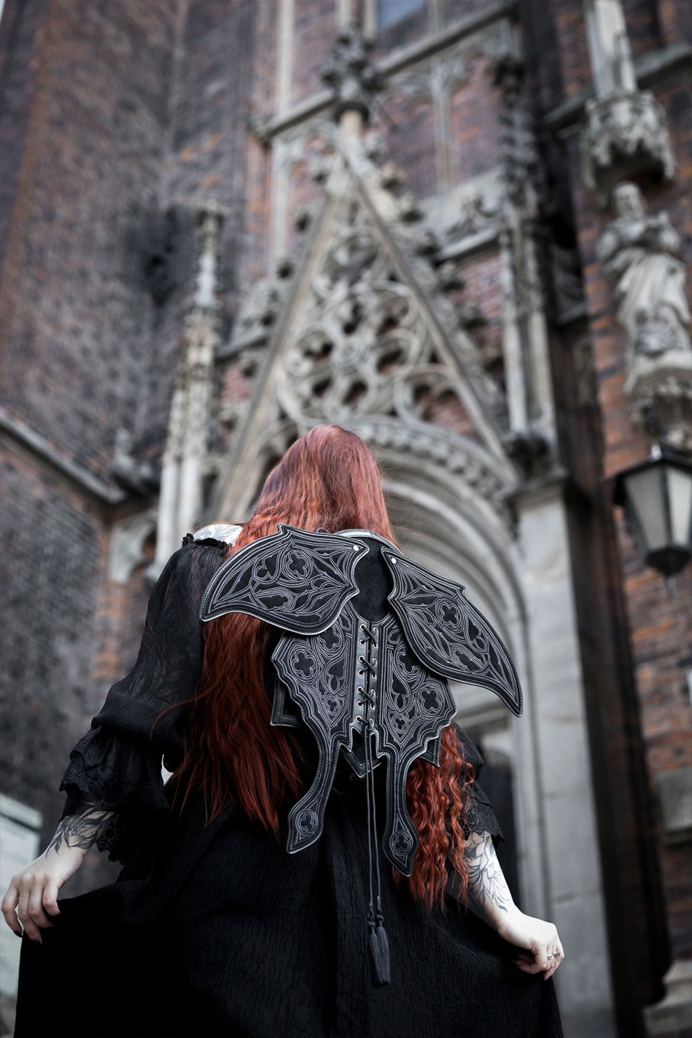 Black suede moth wing backpack worn by model