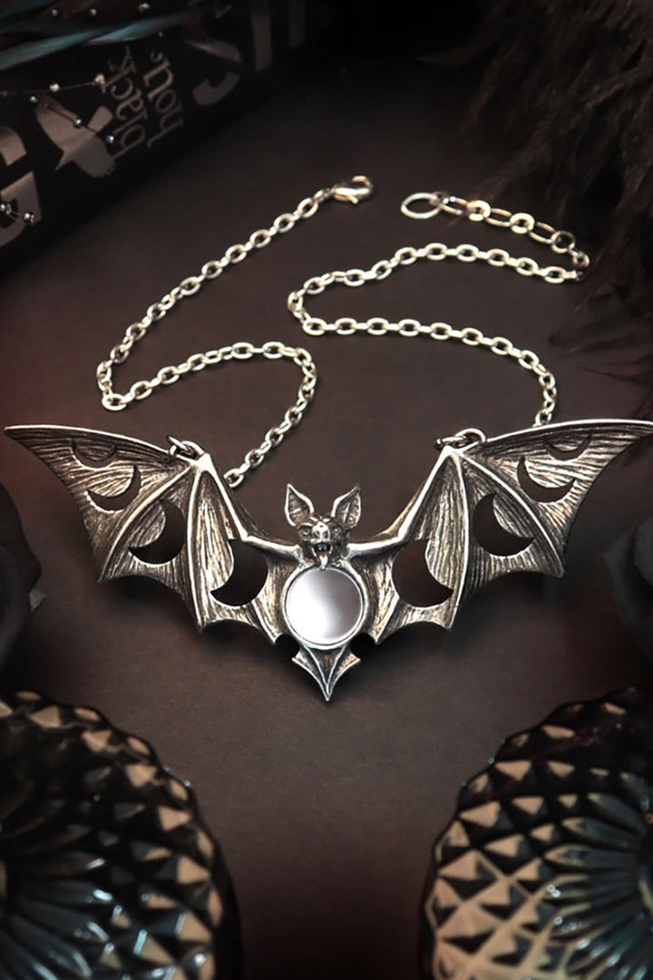 witchy oversized bat necklace with moon phases 
