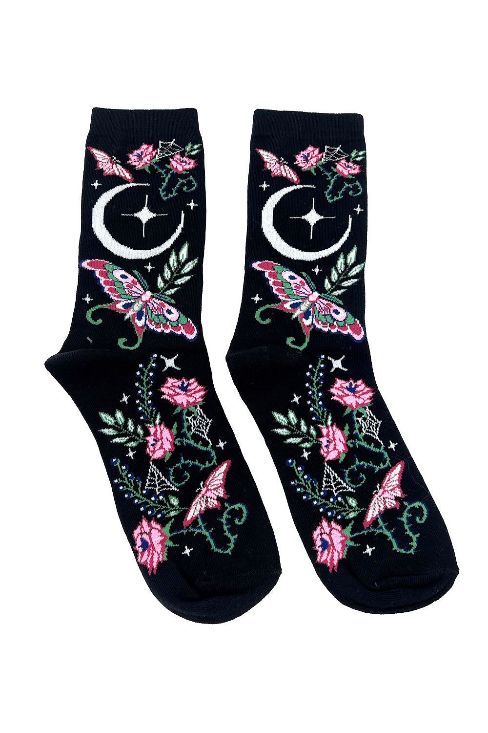 Black socks with pink flowers, green leaves, and white moons on a white background