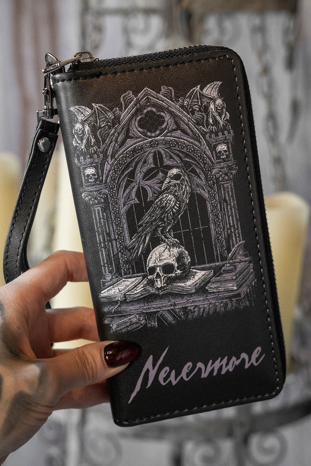 Black vegan leather wallet with gothic design and 'Nevermore' text held by a hand.
