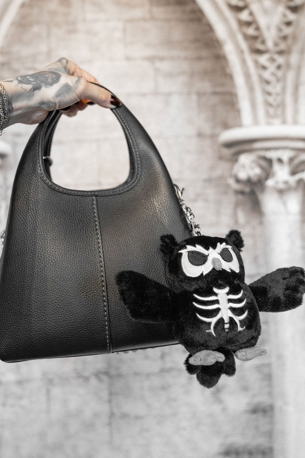 plush skeleton owl keychain on a gothic purse