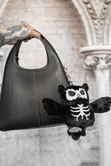 plush skeleton owl keychain on a gothic purse