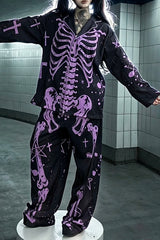 A person wearing a black pajama set with a purple skeleton and occult-style print, standing on a white pedestal in a tiled room.