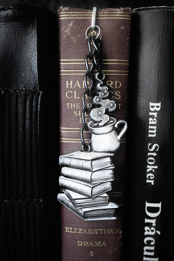 Decorative bookmark with a design of books and a teacup on a book titled 'Dracula' by Bram Stoker.
