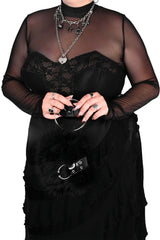 Punk inspired black faux fur handbag with bold metal ring handle and edgy alternative aesthetic