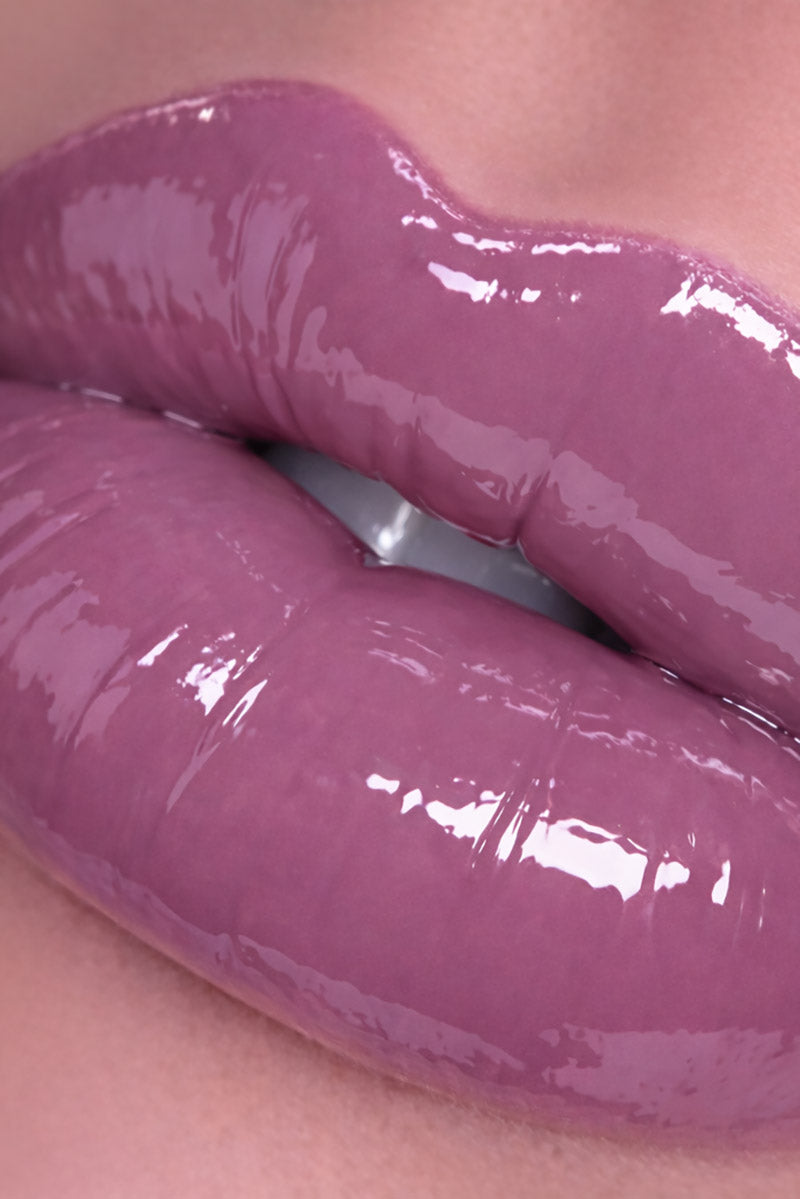 Close-up of glossy purple lipstick on lips