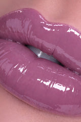 Close-up of glossy purple lipstick on lips