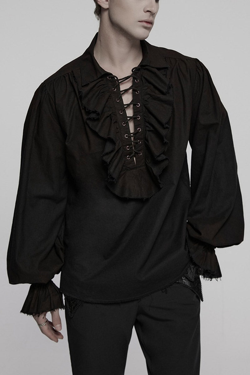 Person wearing a black ruffled shirt with long sleeves on a plain background