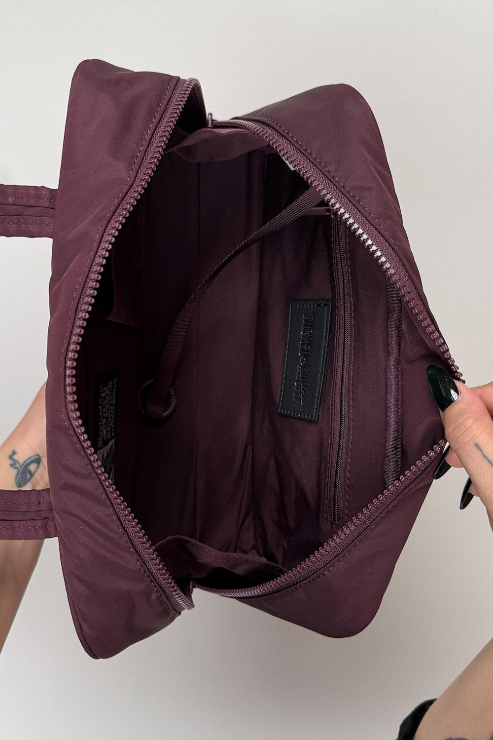 inside a dark red embroidered spiderweb recycled nylon gothic baguette shoulder bag 