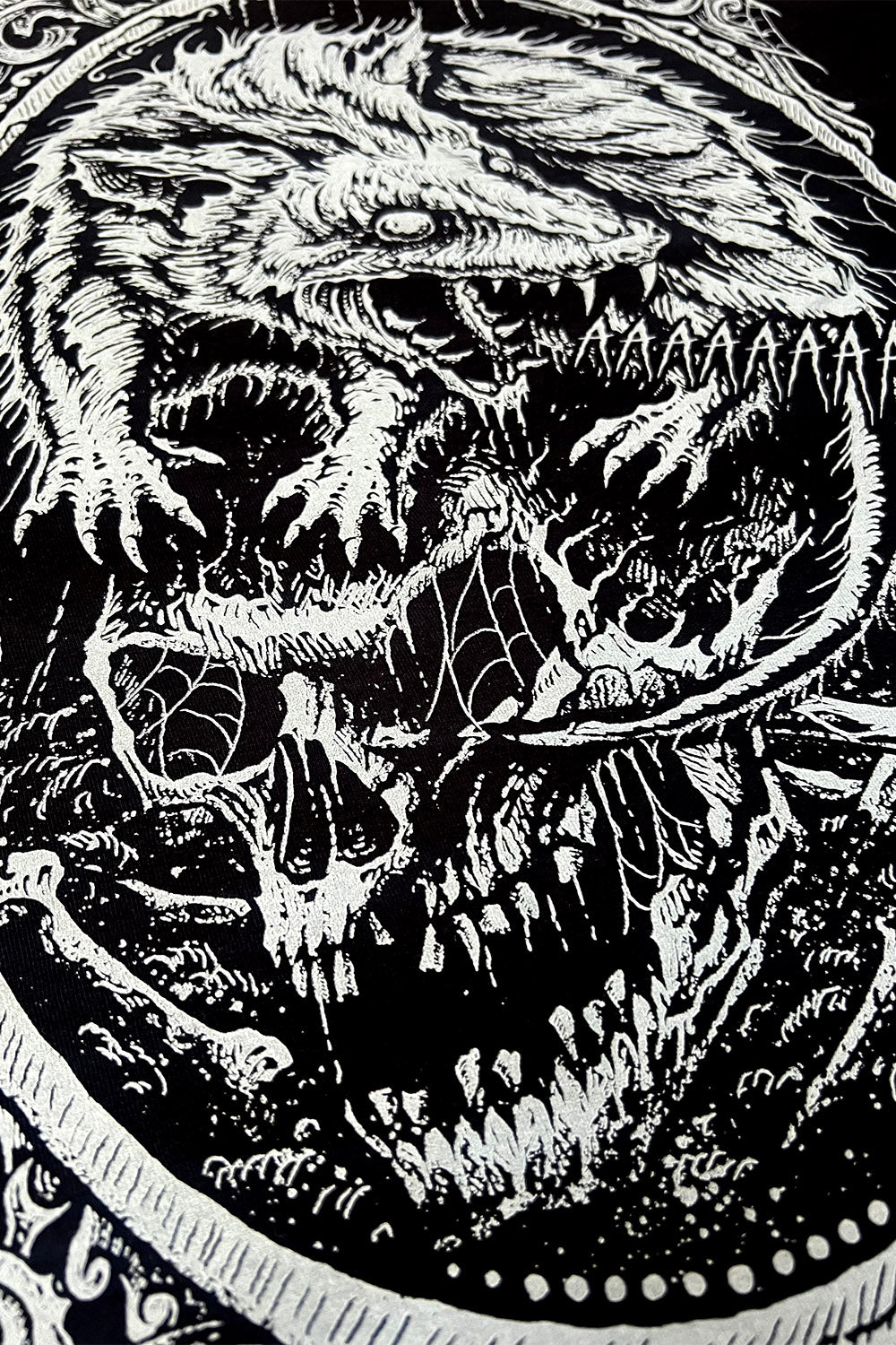 spiderweb-covered skull sweater