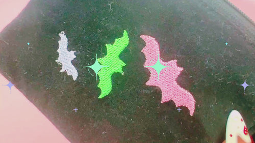video of spooky bat wallet with wristlet strap and embroidered bats 
