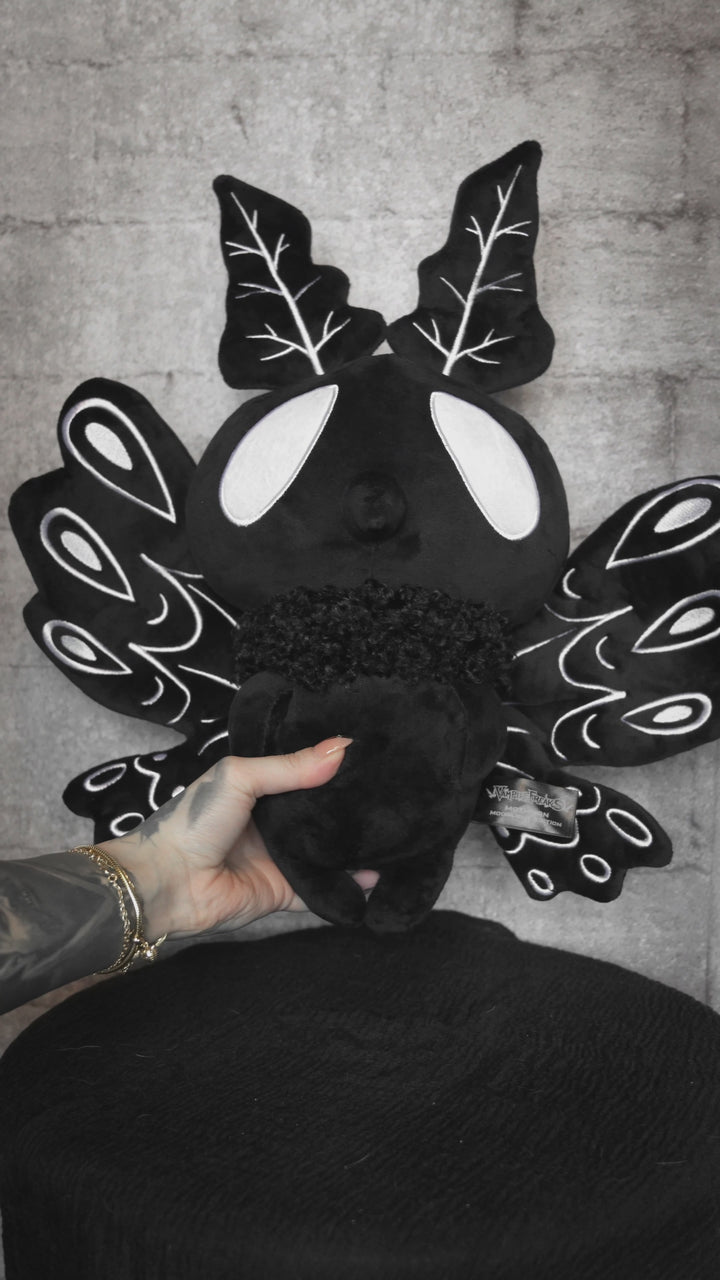 video of a black and white crypti video of a gothic moth plush toy stuffed animad