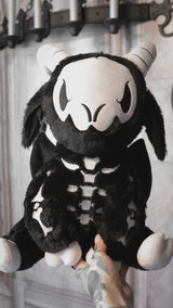video of a large spooky black embroidered goat skeleton stuffed animal plushie