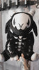 video of a large spooky black embroidered goat skeleton stuffed animal plushie