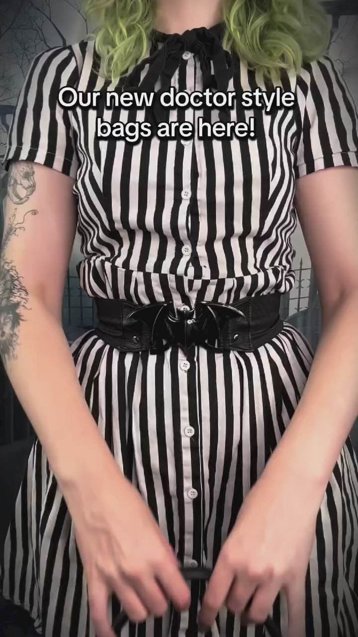 video of a gothic woman using a novelty 3d house shaped halloween spooky bag