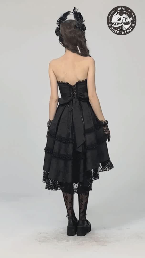 video of a goth woman wearing a dark princess high low hem dress
