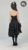 video of a goth woman wearing a dark princess high low hem dress