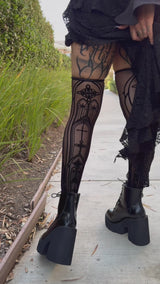 video of a gothic woman wearing black Victorian mesh gothic cathedral thigh high stockings