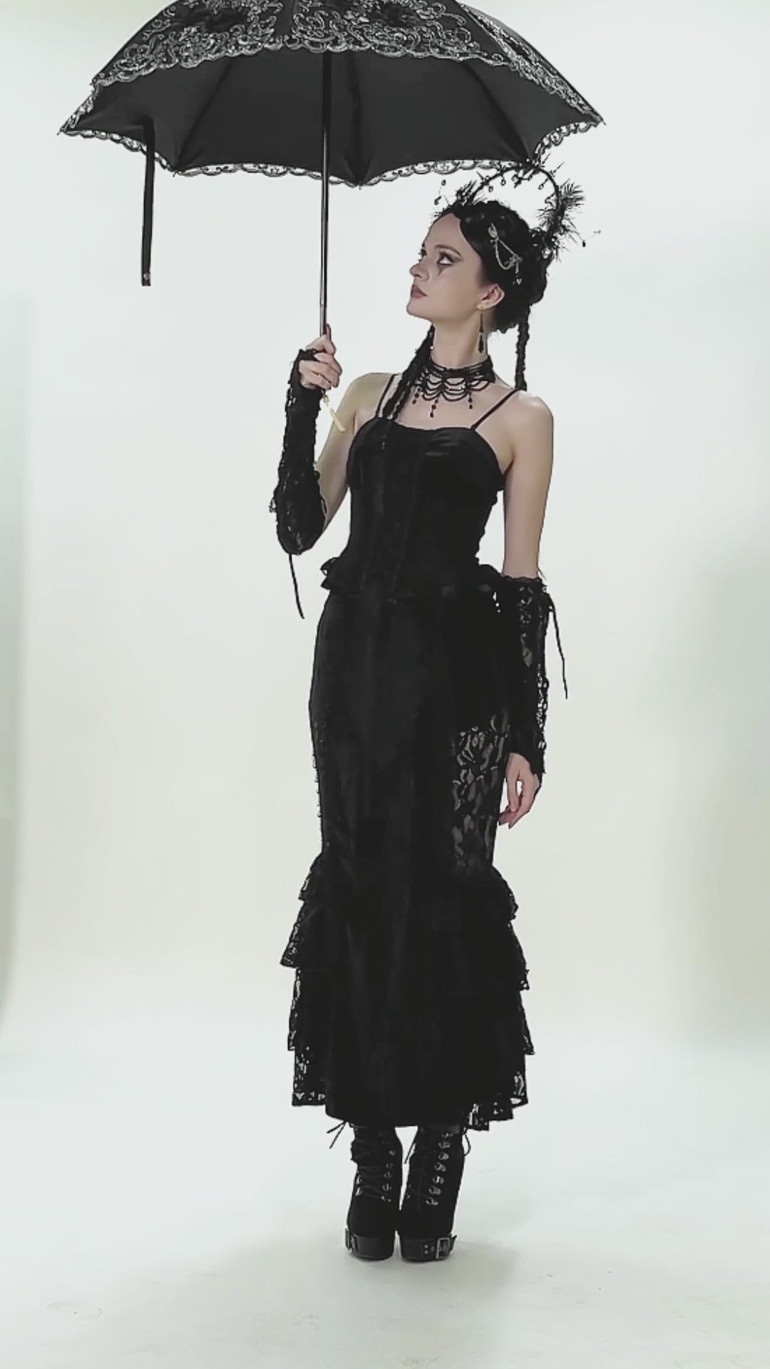 video of a gothic woman using a foldable embroidered lace umbrella